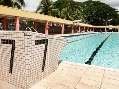 Lane number 7 marked on the tiled edge of an outdoor lap pool